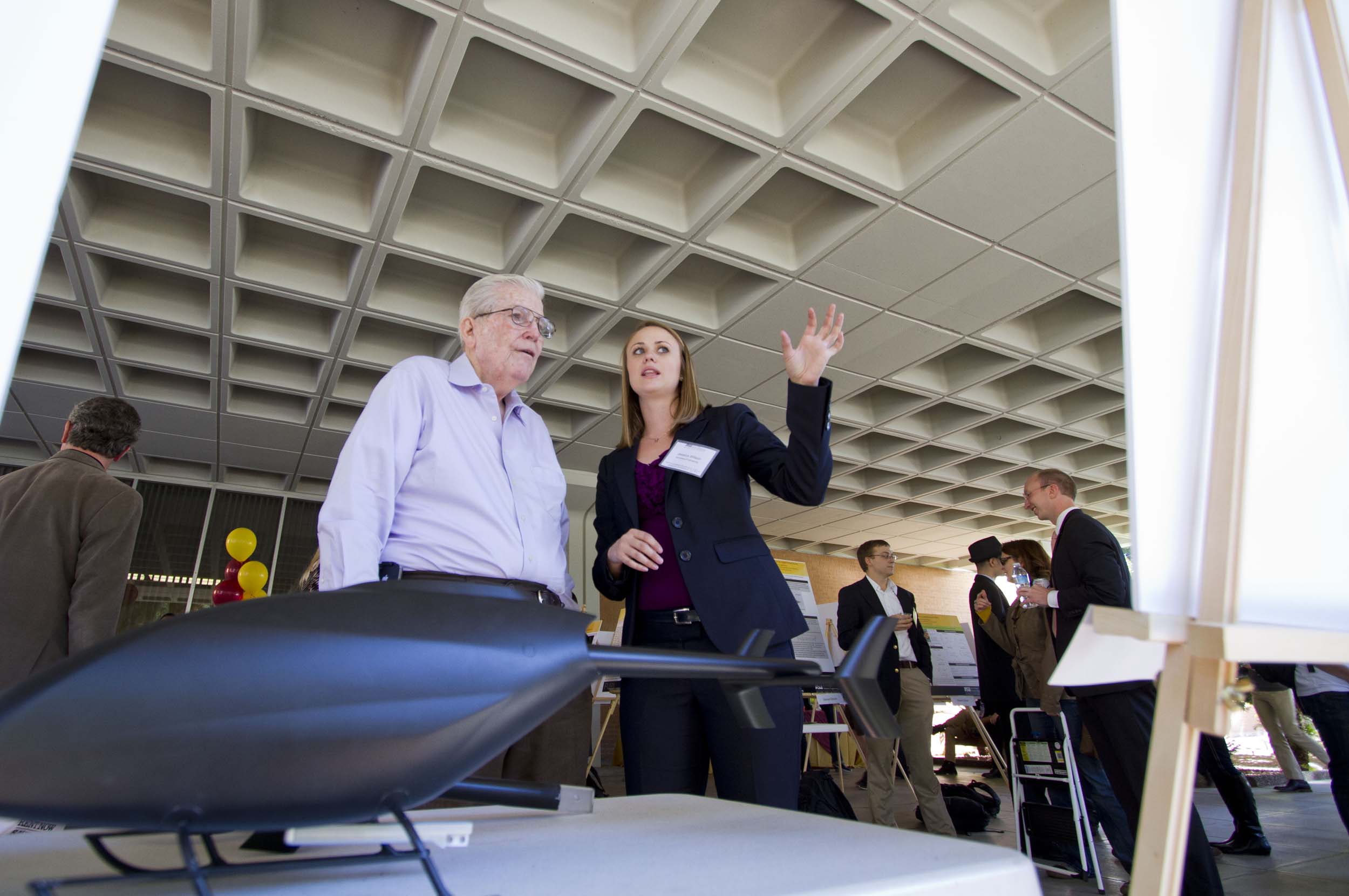 Ira Fulton listens as a student presents during the Fall 2012 FURI Symposium